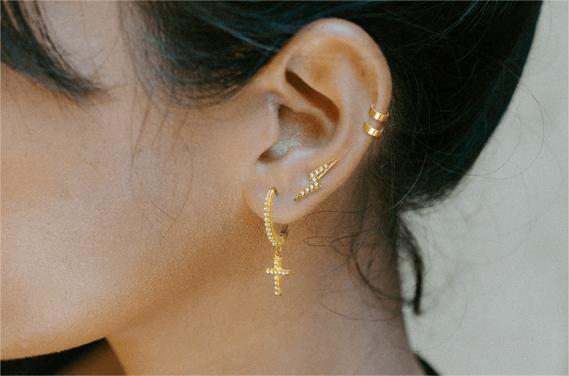 Unveiling the Enigma: Cross Huggie Earrings in Vogue